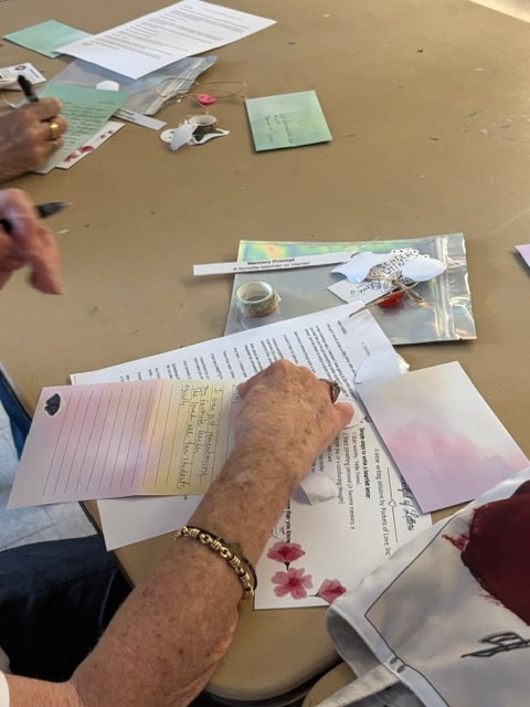 Hands working on letters at a Pockets of Love workshop