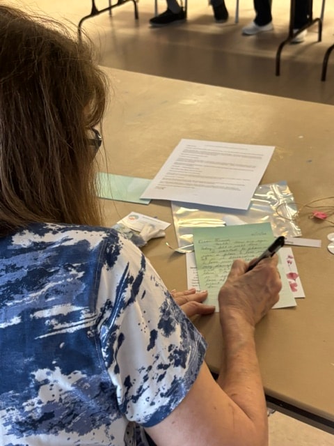 Participant writing at a Pockets of Love letter writing session
