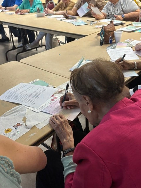 Group writing and drawing at classroom tables